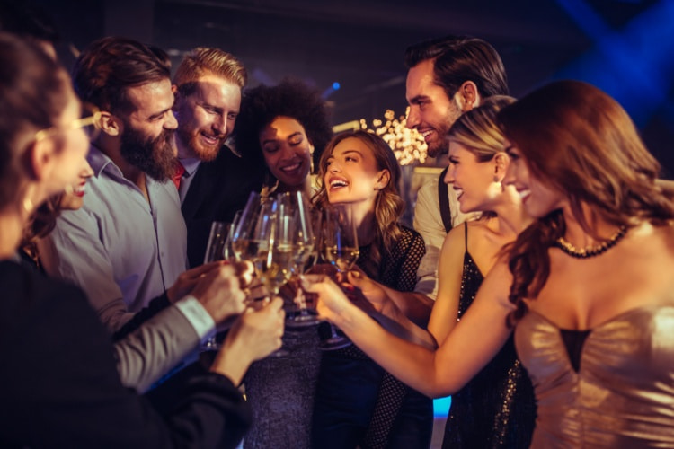 an engaged couple celebrates at their joint bachelor/bachelorette party with friends
